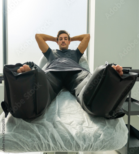 patient lying on a stretcher with air compression pants
