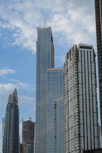 Futuristic and modern commercial and residential highrise tower skyscraper architecture with glass facades and clean lines in downtown Dubai, United Arab Emirates for millionaires and high society