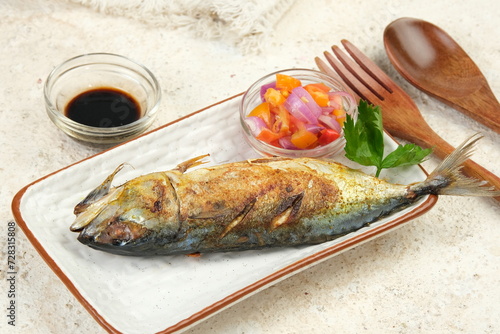 Grilled Mackerel Fish with soy sauce and spicy acar bawang or onion pickles photo