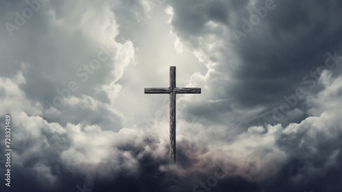 Christian cross on grey cloudy sky background