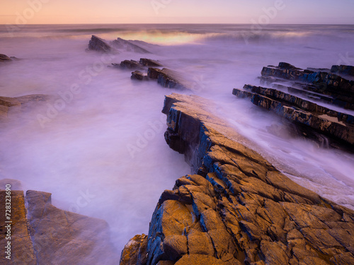 Portugal, Alentejo,Zambujeirado Mar, Long exposure of rocky beach at dusk photo