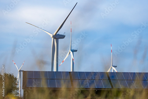 Solar panels and wind farm turbines photo