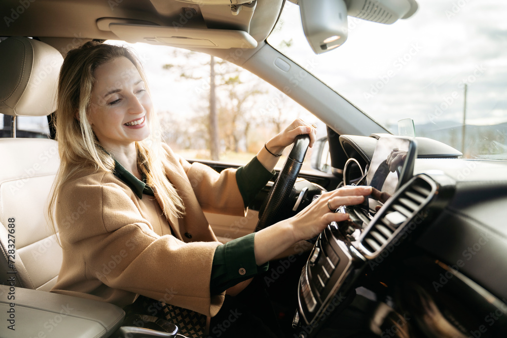 Smiling woman using GPS in car Smiling woman using GPS in car