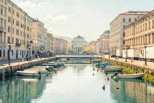 Italy, Friuli-Venezia Giulia, Trieste, Boats moored along Canal Grande in summer photo