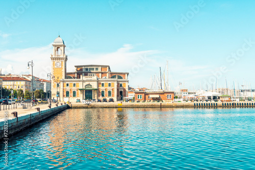 Italy, Friuli-Venezia Giulia, Trieste, Coastal promenade with Salone Degli Incanti event venue in background photo