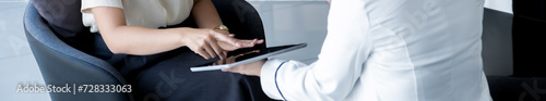 Salesperson presents a product, service, travel, savings, finance, investment or life insurance to a businesswoman using a tablet device
