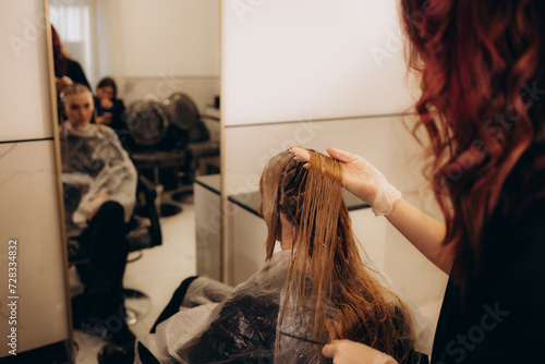 hairdresser coloring hair of her customer