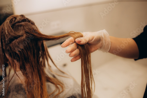hairdresser coloring hair in studio