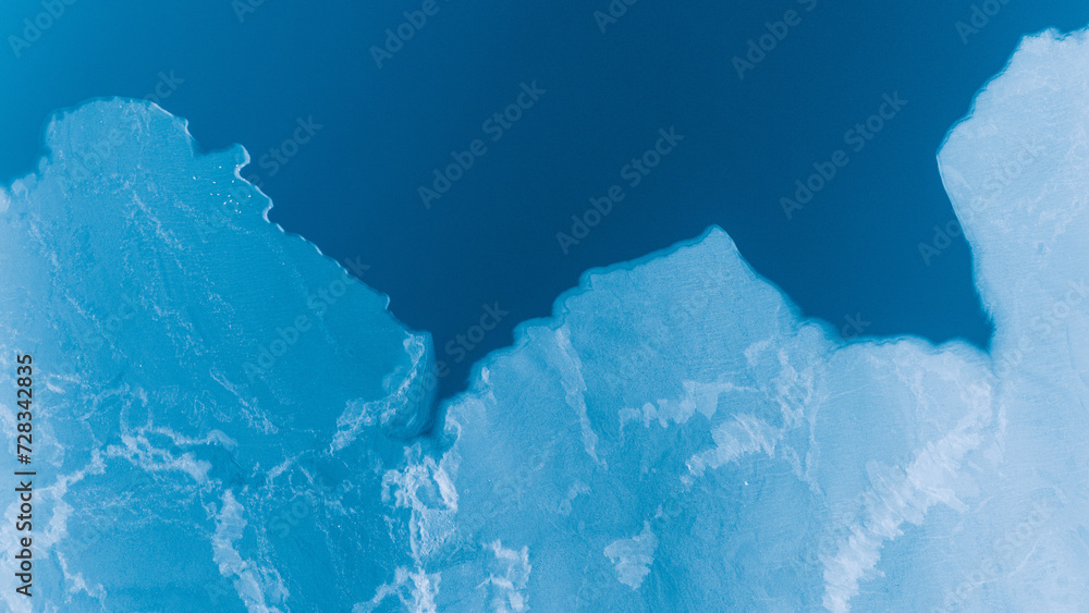 Arial View of a frozen Fjord transitioning into calm water in the North of Norway