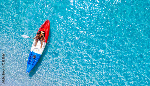 Aerial view of a kayak in the blue sea .Woman kayaking She does water sports activities	 photo