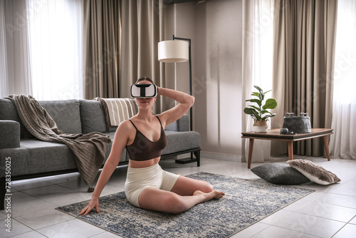 Workout fit vr,Fitness vr home ,VR fit.Girl doing fitness in VR glasses ,virtual reality exercise, immersive workout,VR sports,virtual gym,spatial computing, augmented reality helmet, AR headset photo
