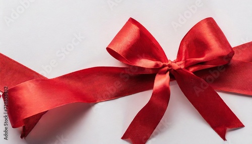 panoramic shot of red ribbon with bow on white