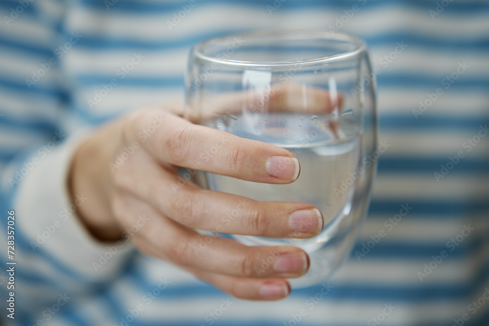 Woman drinks water, Close-up shot of man holding glass of fresh water, Quenching thirst, Lifestyle healthcare concept Woman drinks water, Close-up shot of man holding glass of fresh water, Quenching thirst, Lifestyle healthcare concept