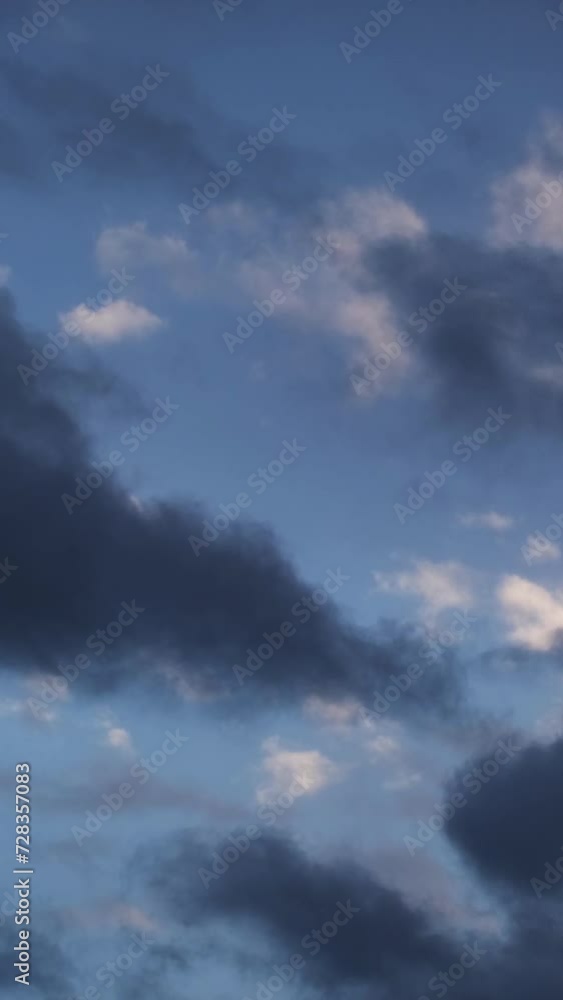 Slow motion close-up of fluffy dark clouds moving quickly against the blue sky. Magnificent dramatic nature on a windy autumn evening. Relaxing or meditative, continuously changing cloudscapes. Slow motion close-up of fluffy dark clouds moving quickly against the blue sky. Magnificent dramatic nature on a windy autumn evening. Relaxing or meditative, continuously changing cloudscapes.