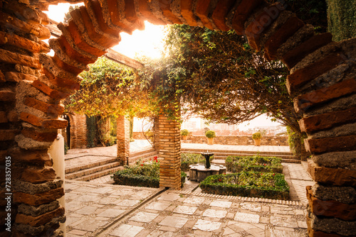 Plaza de Armas with its lovely fountain  pergola and garden  Alcazaba of Malaga  Andalusia  Spain