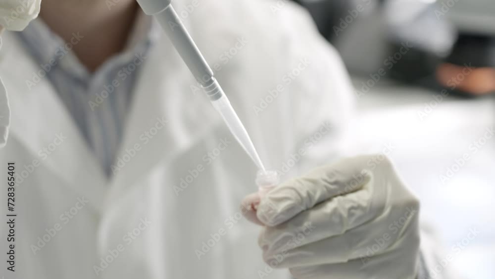 Closeup shot of scientist hands in white gloves getting sample using absorption pipette Closeup shot of scientist hands in white gloves getting sample using absorption pipette