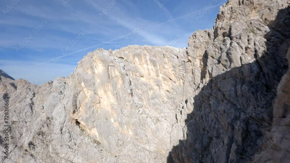 FPV racing drone flying across the Italian Dolomites extreme mountain range rocky ridge FPV racing drone flying across the Italian Dolomites extreme mountain range rocky ridge