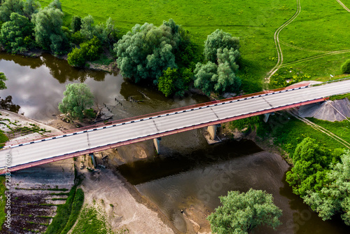 Aerial view of a road bridge over a small river