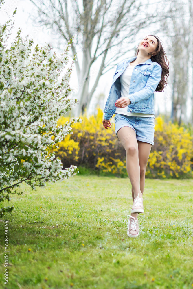 Healthy happy woman on spring outdoors. Smiling young woman on the spring garden enjoy blooming flowers of tree. Enjoy Nature. No allergy. Healthy happy woman on spring outdoors. Smiling young woman on the spring garden enjoy blooming flowers of tree. Enjoy Nature. No allergy.
