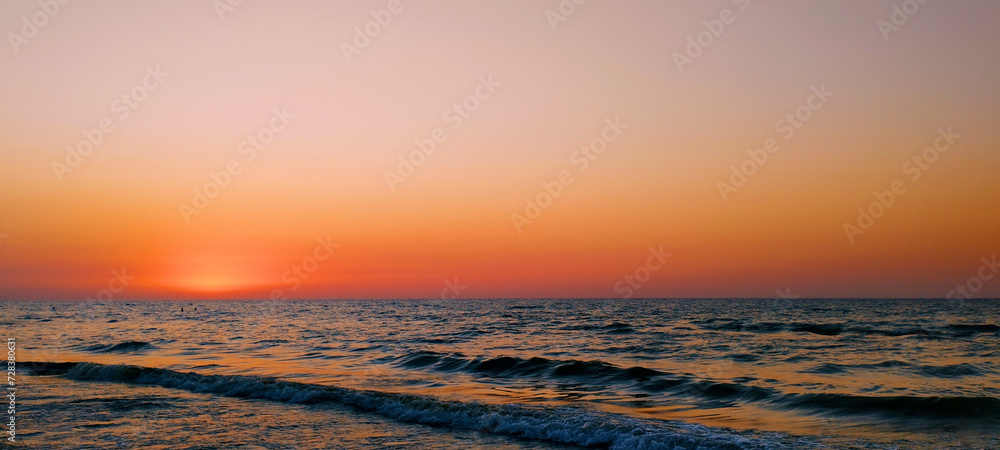 Beautiful sunset in the sea with calm waves
