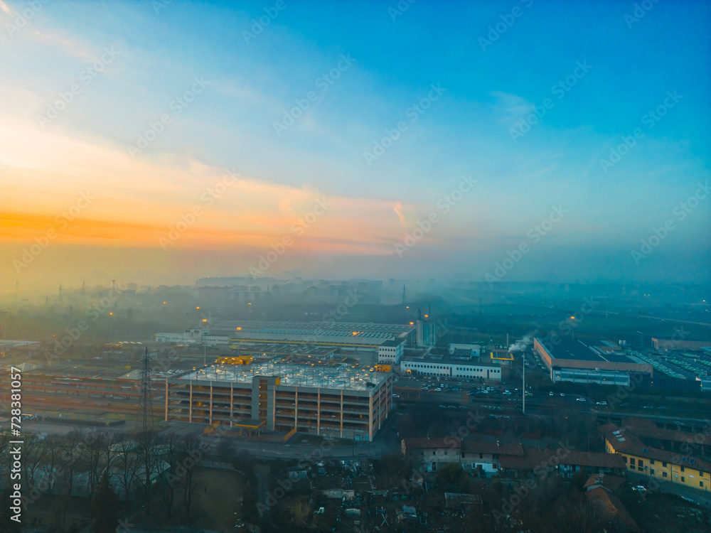 Foggy sunrise with San Donato Milanese skyline from a drone, Lombardia, Milano, Italia 4.02.2024