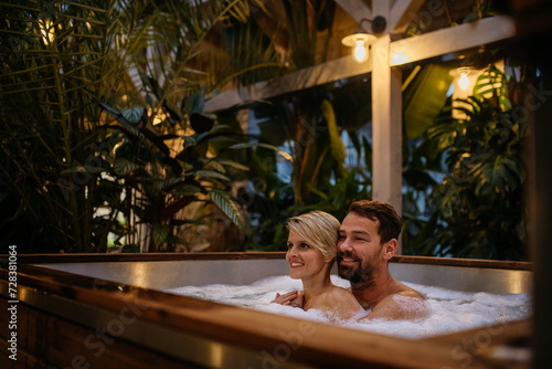 Beautiful mature couple relaxing in hot tub, enjoying romantic wellness weekend in spa. Concept of Valentine's Day. © Halfpoint