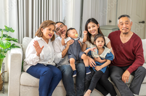Portrait of happy love asian grandfather with grandmother playing with asian baby and little cute girl hug,Big family love with father and mother smiling together.Family and togetherness