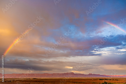 Echo Cliffs with dramatic sky at sunset near Great Canyon with rainbow