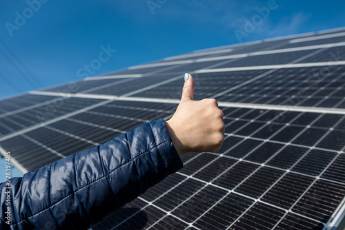 hand of female engineer checking solar operation cleanliness of photovoltaic solar panels sun.