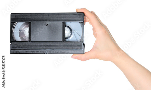 Woman hand holds a retro old analog video cassette, isolated on white background, retro things concept