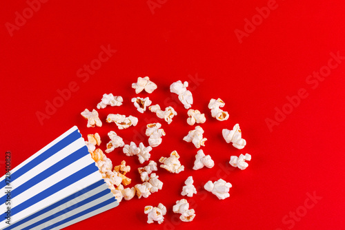 box with popcorn striped in different colors on a red background