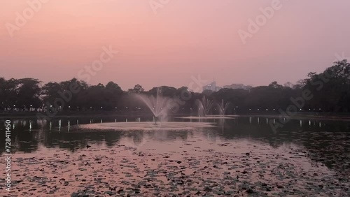 Static shot of sunset at Rabindra Sarobar lake with beautiful fountains in Kolkata, India. photo