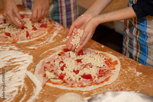 Making dough and pizza by a child.