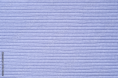 Blue knitted background from woollen yarns or cotton. Abstract texture of a knitted fabric surface. photo