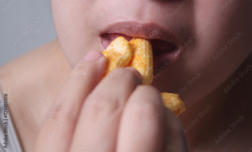 Woman eating crispy cornflakes, It is a popular street food that is delicious and commonly found in Asian Woman eating crispy cornflakes, It is a popular street food that is delicious and commonly found in Asian