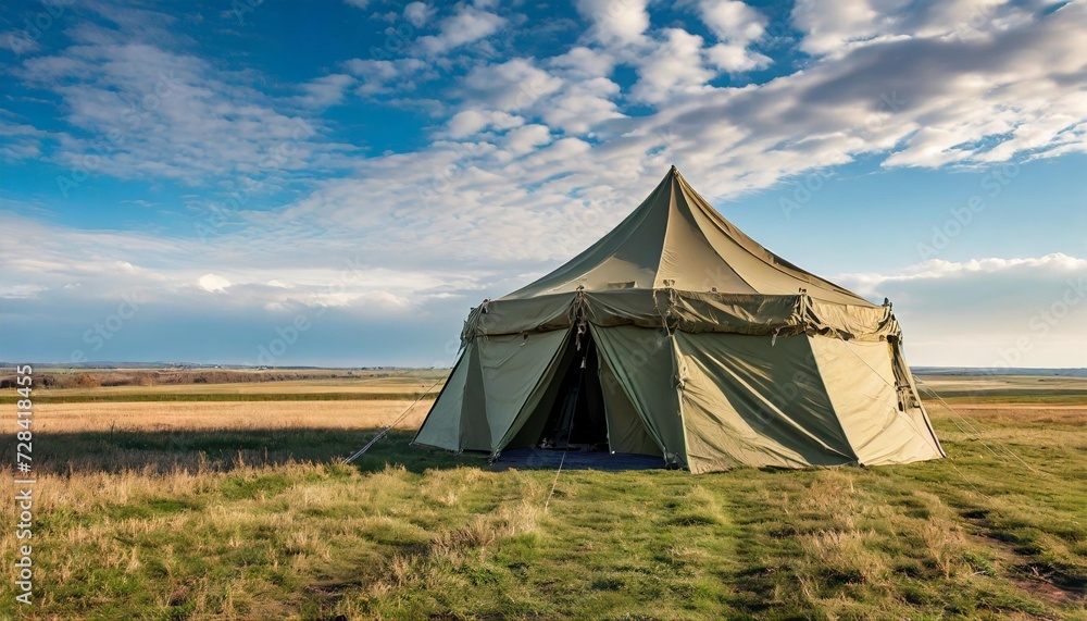 a very large military tent standing in a vast field highlighting the strategic importance of field camps ideal for military and defense concepts