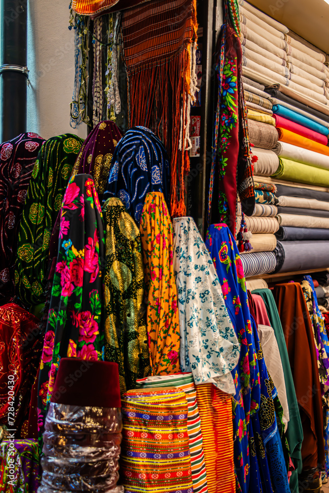 Fototapeta premium Traditional Turkish clothes in the bazaar, a vibrant display of cultural textiles, patterns, and garments, creating a marketplace of diverse textures and fashion.