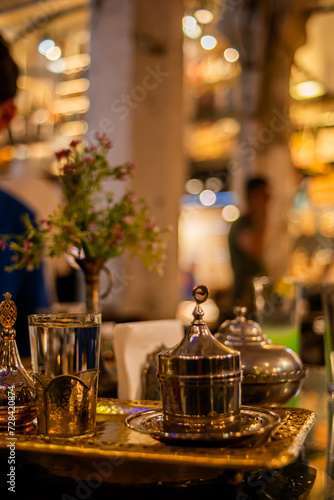 Explore the opulence of an old Turkish coffee set, a vintage display of ornate copper and ceramic artifacts, preserving cultural heritage and offering a timeless brewing experience.