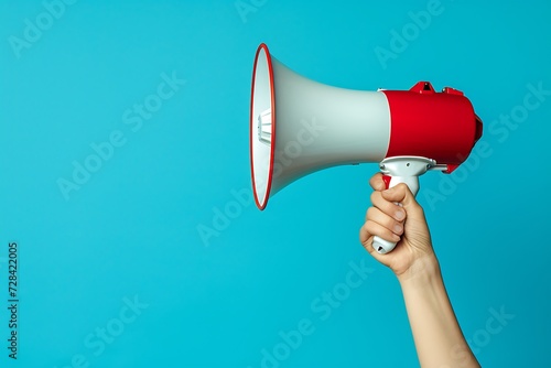 megaphone in hand isolated on blue background