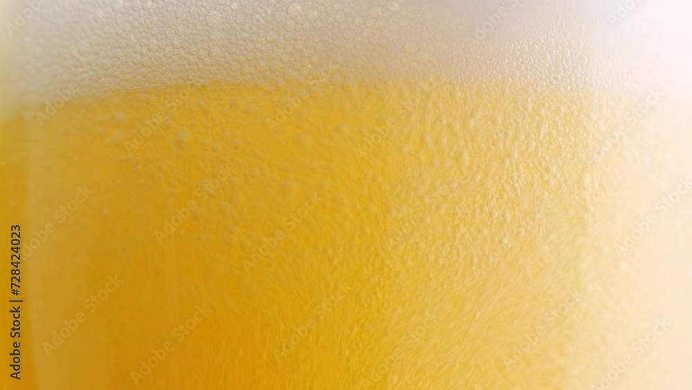 Beer pours into a glass, forming effervescent bubbles and a frothy head. Detail shot, macro. beer capturing the spirit of octoberfest celebration . alcoholic drink Beer pours into a glass, forming effervescent bubbles and a frothy head. Detail shot, macro. beer capturing the spirit of octoberfest celebration . alcoholic drink