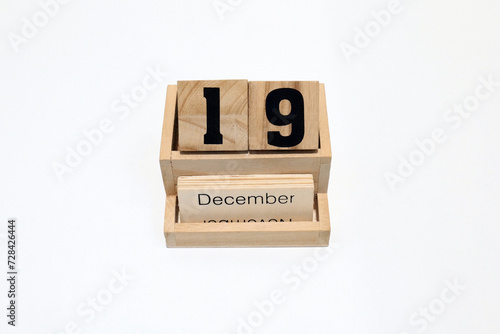19th of December wooden perpetual calendar. Shot close up isolated on a white background