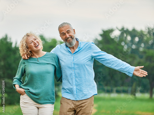 woman man mature couple happy together active bonding park outdoor middle aged talking leisure park fun smiling love old middle mid aged nature wife walking © Lumos sp