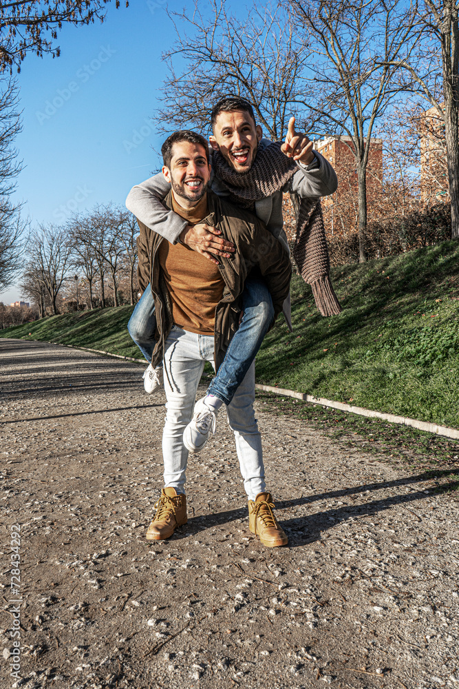 Fototapeta premium Man piggybacking his boyfriend