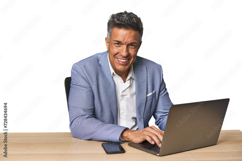 Middle-aged Hispanic man working on laptop in business suit Middle-aged Hispanic man working on laptop in business suit