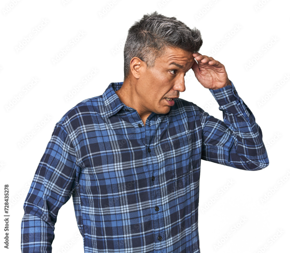 Middle-aged Latino man looking far away keeping hand on forehead. Middle-aged Latino man looking far away keeping hand on forehead.