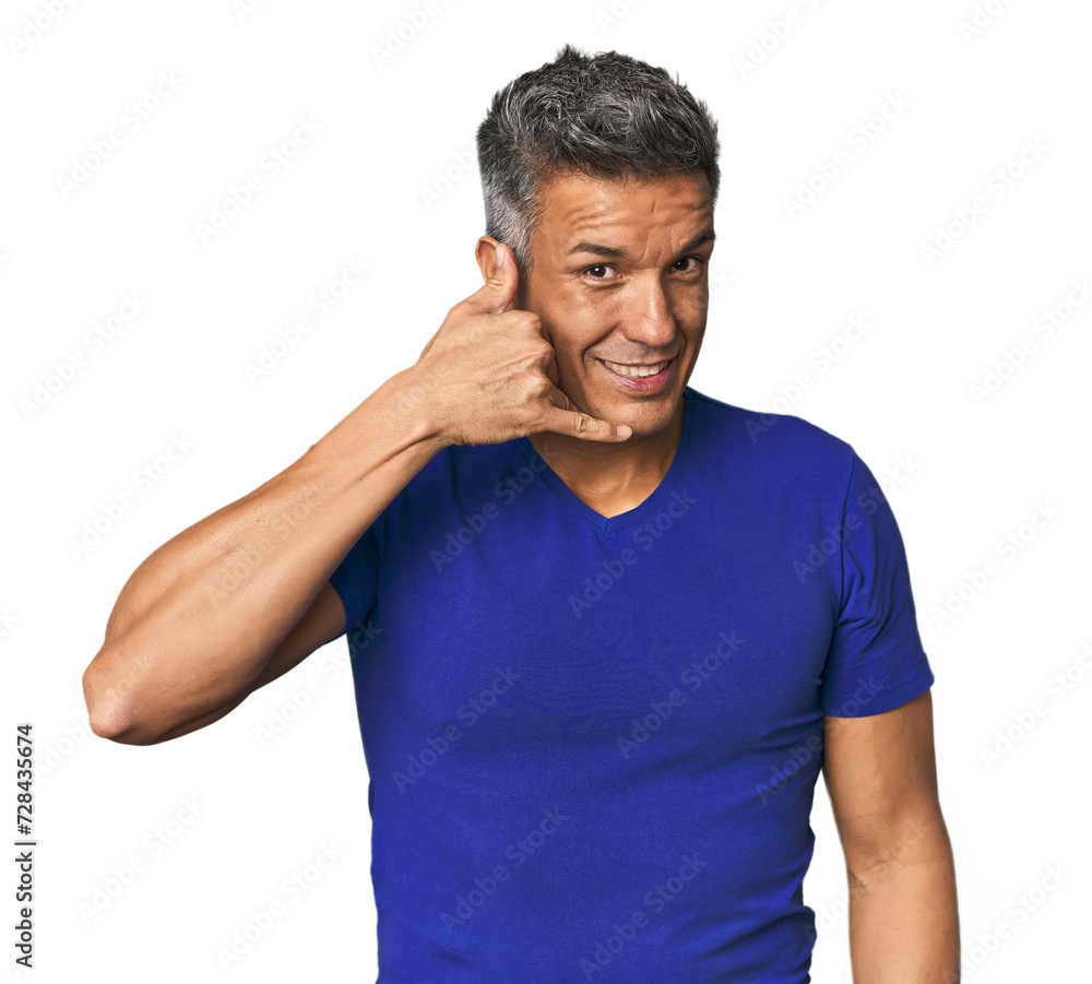 Middle-aged Latino man showing a mobile phone call gesture with fingers. Middle-aged Latino man showing a mobile phone call gesture with fingers.