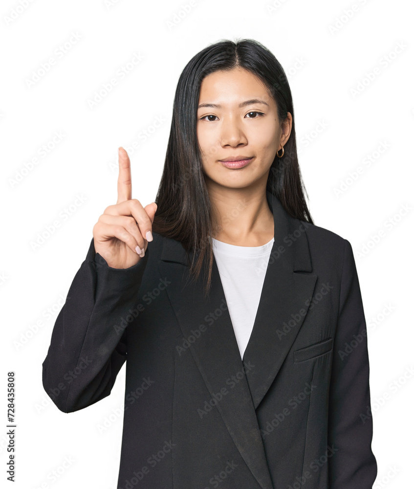 Young Chinese woman in business suit showing number one with finger. Young Chinese woman in business suit showing number one with finger.