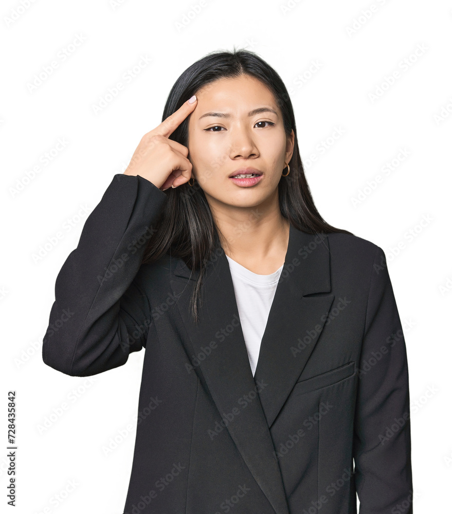 Young Chinese woman in business suit showing a disappointment gesture with forefinger. Young Chinese woman in business suit showing a disappointment gesture with forefinger.