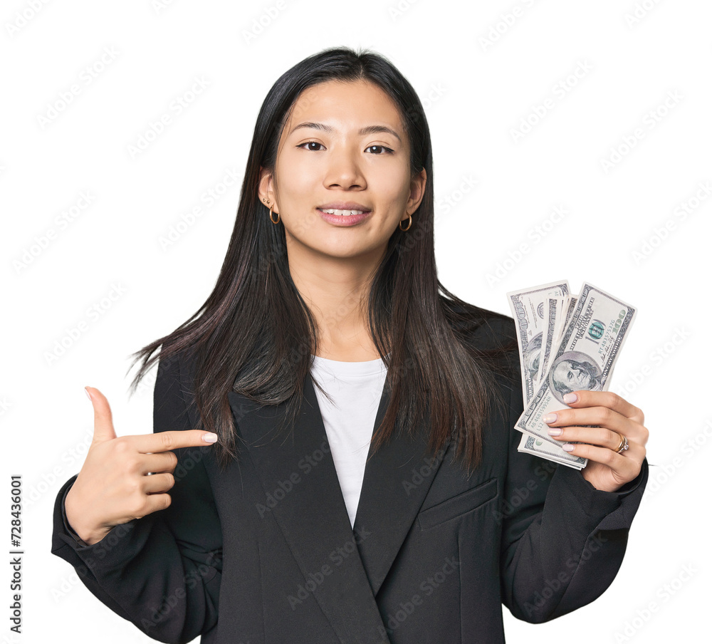 Young Chinese woman with dollars in suit person pointing by hand to a shirt copy space, proud and confident Young Chinese woman with dollars in suit person pointing by hand to a shirt copy space, proud and confident