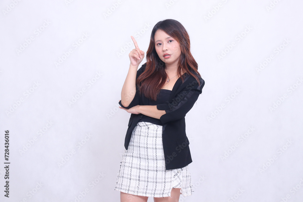 beautiful girl asian indonesia 20s formal office shocked relaxed arms crossed pointing right up obliquely isolated white background